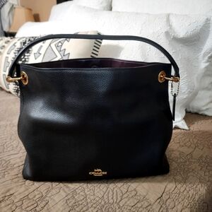 Coach Clarkson Hobo bag in black polished pebble leather.
